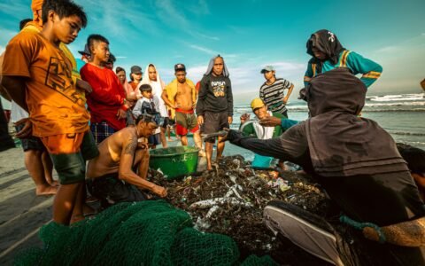 Volunteers sorting trash during a beach cleanup
